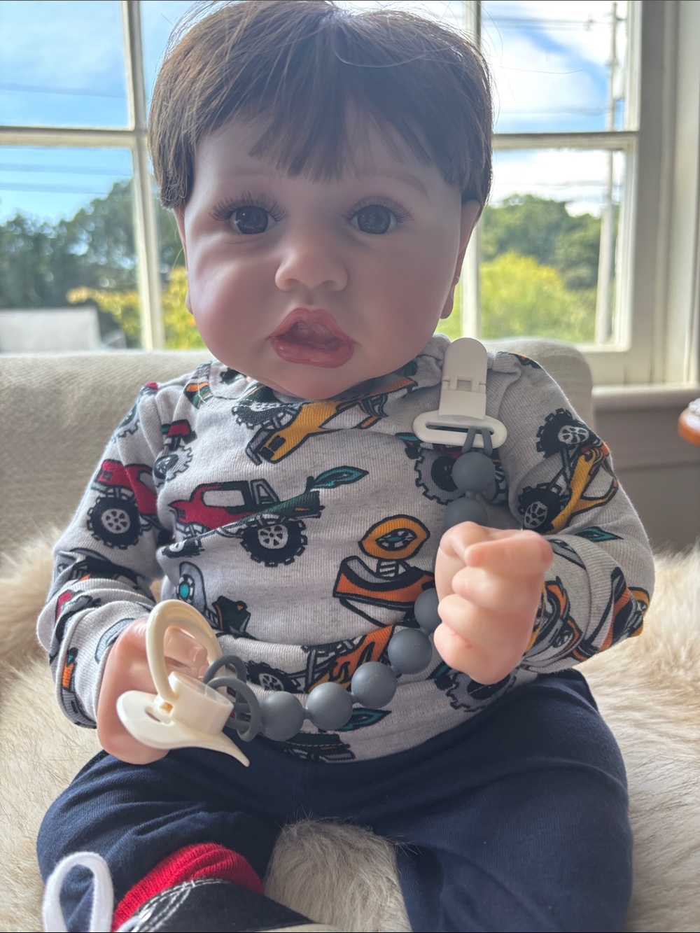 Baby Doll with Gray Pacifier Clip and Colorful Truck Outfit